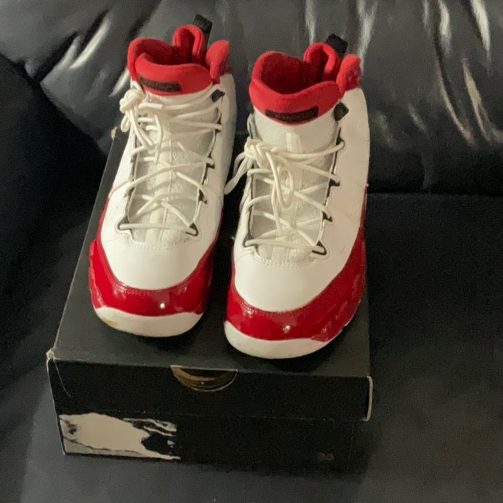 Kids Air Jordan 9 Retro PS red and white leather sneaker.